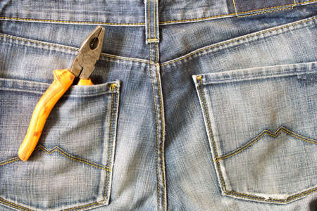 Labor day.  Pliers in jeans pocket .の写真素材
