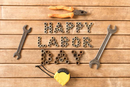 Labor day.  Different tools on a wooden table .の写真素材