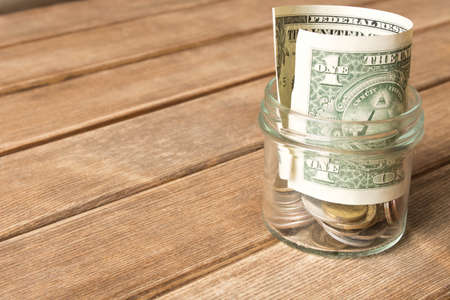 Dollar bill on a wooden table . Last dollar.  The concept of poverty .の写真素材