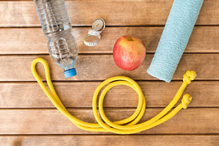 Sports accessories on wooden background . Healthy lifestyle .
