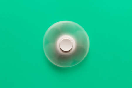 The rotating spinner . Isolated on turquoise background .の写真素材