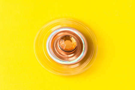 The rotating spinner. Isolated on yellow backgroundの写真素材