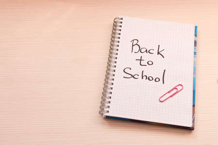 Notebook with the inscription back to school on the Desk . School concept .