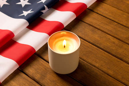 American flag and memorial candle on veterans day . On wooden background .の写真素材