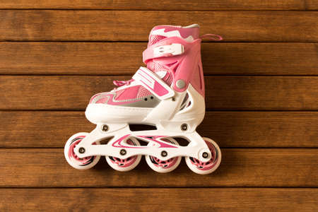 Roller skates on wooden background . Sport.  Healthy lifestyle .