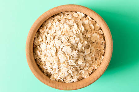 A bowl of cereal on a turquoise background. The concept of healthy food . Top view .