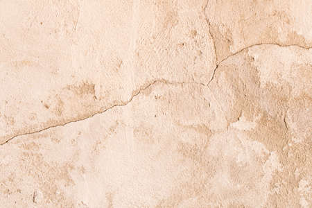 An old crumbling cement wall . Background texture of old wall .