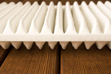 New car air filter on wooden table.の写真素材