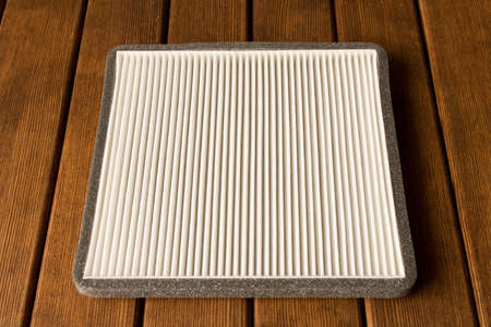 New car interior filter on wooden table.の写真素材
