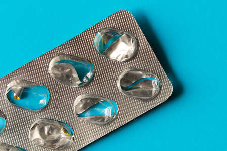 Empty pack of pills on turquoise background. Close upの写真素材