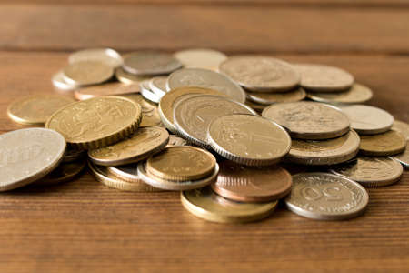 Many different coins on the table. The concept of poverty.の写真素材