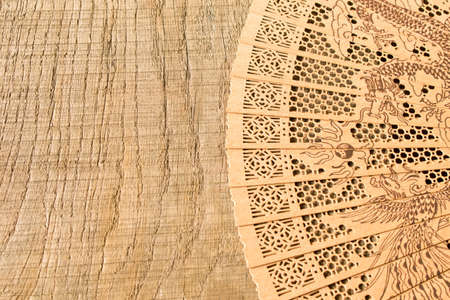 Beautiful wooden fan on the old table.の写真素材