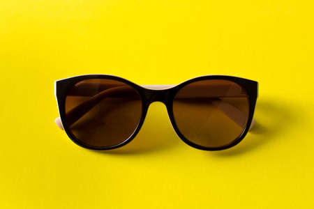 Sunglasses on yellow background. The concept of summer. Empty text space.の写真素材