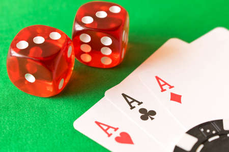 Dice and playing cards on the green table. Winning concept