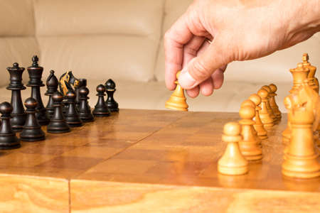 A chess pawn in a human hand. The beginning of the chess game. The concept of chess