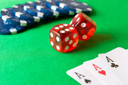 Dice, poker chips and playing cards on the green table . Game concept. Games of chance.の写真素材