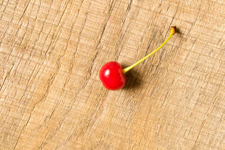 Ripe red cherry on an old wooden table. The concept of natural food.の写真素材