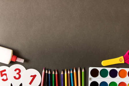 Various school supplies on the blackboard background . The concept of education. With empty space...