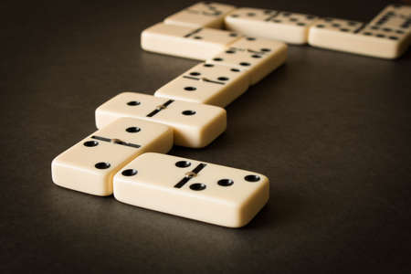 A game of dominoes on a dark table . The concept of the game of dominoes. Close up.の写真素材