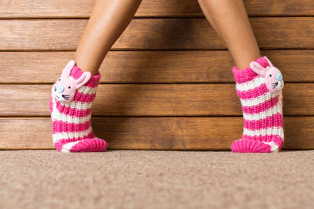 Funny pink socks on the legs of a little girl.の写真素材