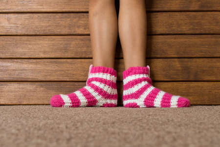 Funny pink socks on the legs of a little girl.の写真素材