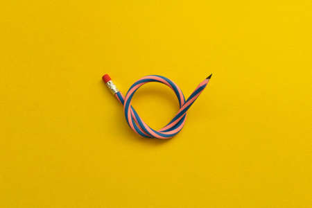 Flexible pencil . Isolated on yellow background.の写真素材