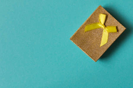 A small gift on a blue background. The concept of a gift made with your own hands.の写真素材