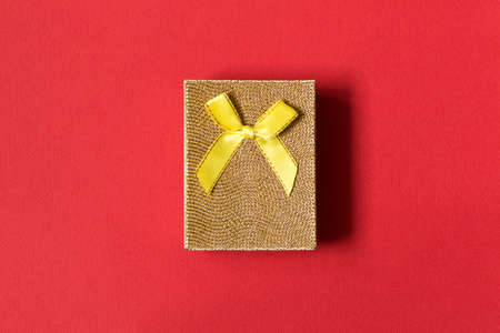 A small gift on a red background. The concept of a gift made with your own hands.の写真素材