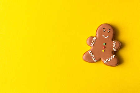 Funny gingerbread man on yellow background
