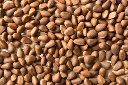 Pine nuts background texture. Natural food. Selective focus.