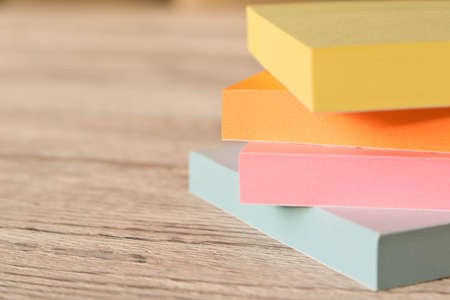 Packages of colorful stickers for notes on a wooden tableの写真素材