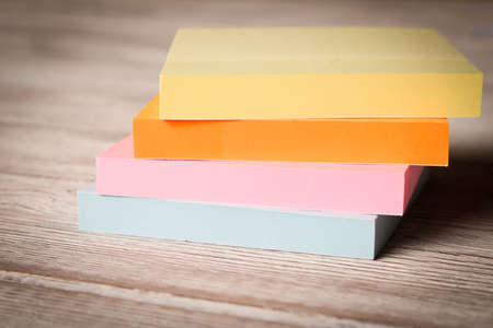 Packages of colorful stickers for notes on a wooden tableの写真素材