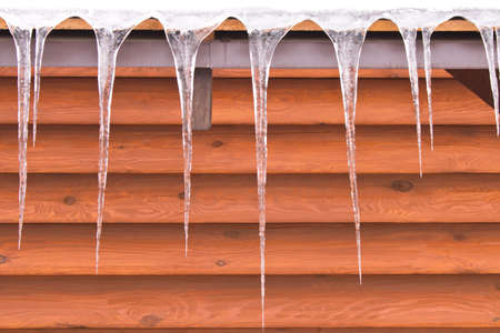 Icicles hanging from the roof. The concept of a cold winterの写真素材