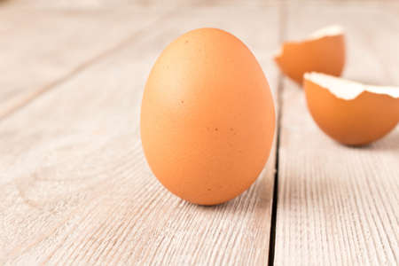 Chicken egg and eggshell on wooden table. Selective focusの写真素材