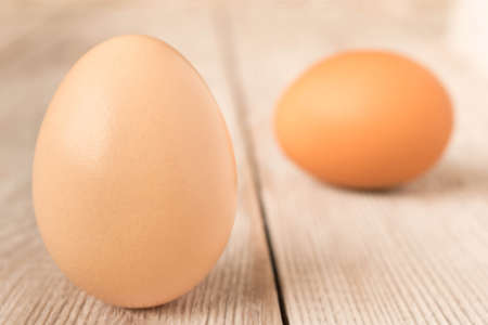 Chicken eggs on a wooden table. Selective focusの写真素材