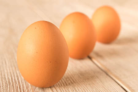 Chicken eggs on a wooden table. Selective focusの写真素材