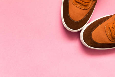A pair of new sneakers on a pink background. Empty text spaceの写真素材