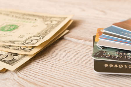 Credit cards and cash dollars. The concept of funding. Selective focusの写真素材