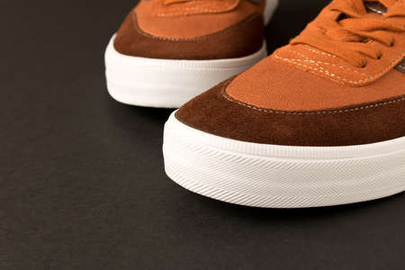 A pair of new sneakers on a dark background. Empty text spaceの写真素材