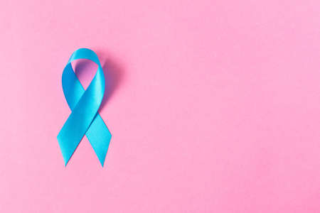 Blue ribbon.  Isolated on pink background with empty space for text. Close upの写真素材