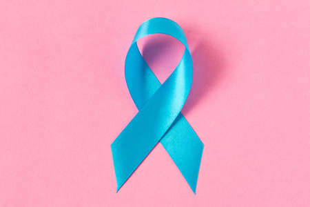 Blue ribbon.  Isolated on pink background with empty space for text. Close upの写真素材