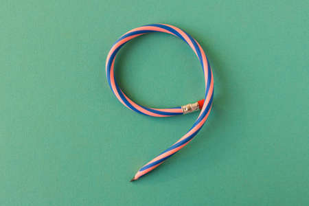 Flexible pencil. Isolated on light background. Bending pencil