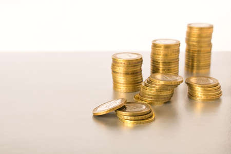 Stacks of coins on a light background. Business concept and growth of capitalの写真素材