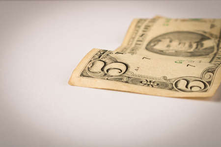 Old 5 dollar bill on a white background. Close up. The concept of saving money