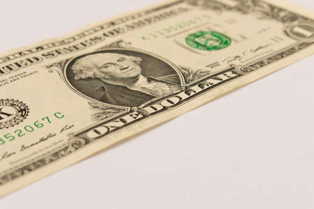 1 dollar bill on a white background. Close up. The concept of saving money