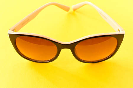 Sunglasses on yellow background. The concept of summerの写真素材