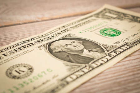 1 dollar bill on a white background. Close up. The concept of saving money