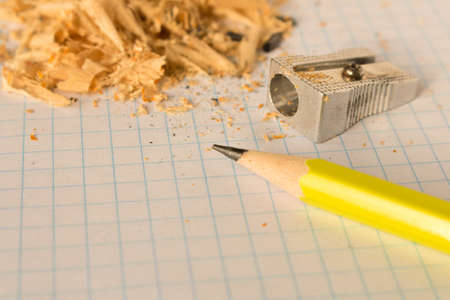 A simple pencil and sharpener on a clean sheet of paper. Selective focusの写真素材