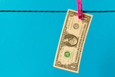 1 dollar bill on the clothesline. The concept of money laundering.の写真素材