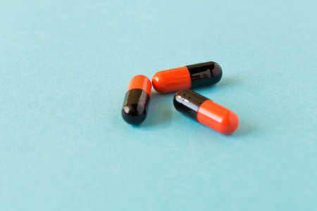 Few pills scattered on blue background . Birth control pills. Selective focusの写真素材